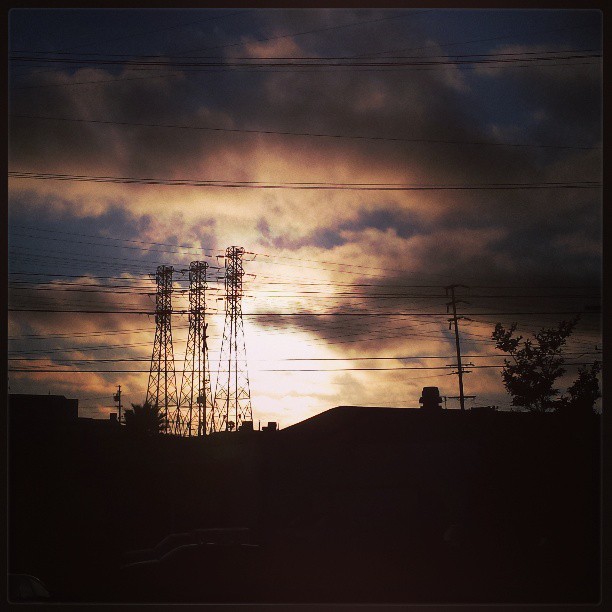 Cloudy sunset behind power lines.