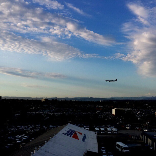 Cloud shadows and an airplane.