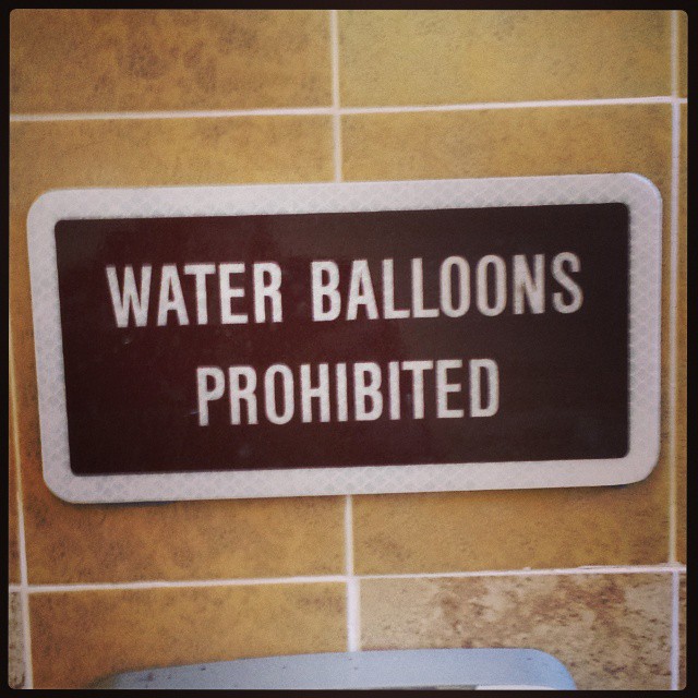 Sign in a park bathroom. I’d like to think on a day like today they’d make an exception. I don’t think anyone would mind being hit by a water balloon in 100+ degree heat. #heatwave #park #waterballoon #hot
