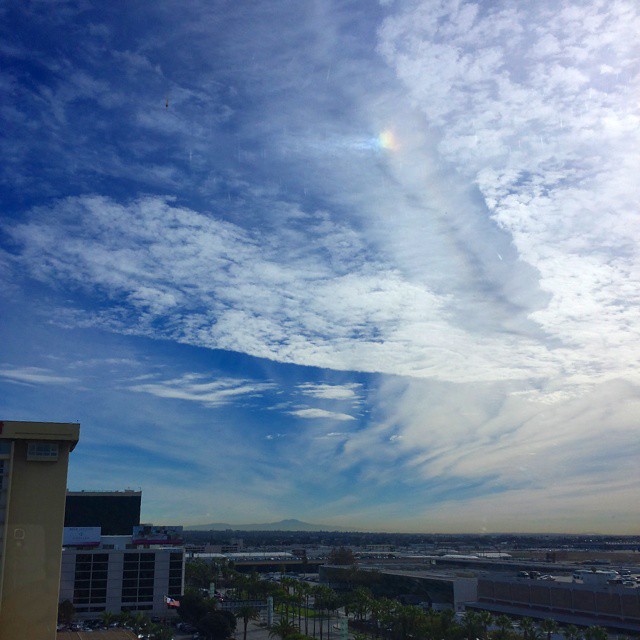 Sundog, Saddleback, clouds and dust, seen from near LAX. The Santa Ana winds have cleared away the smog, making the view unusually clear (until the dust takes its place). As for the sundog, timing is everything with halos: I went to grab a cup of coffee and it was already gone when I got back.