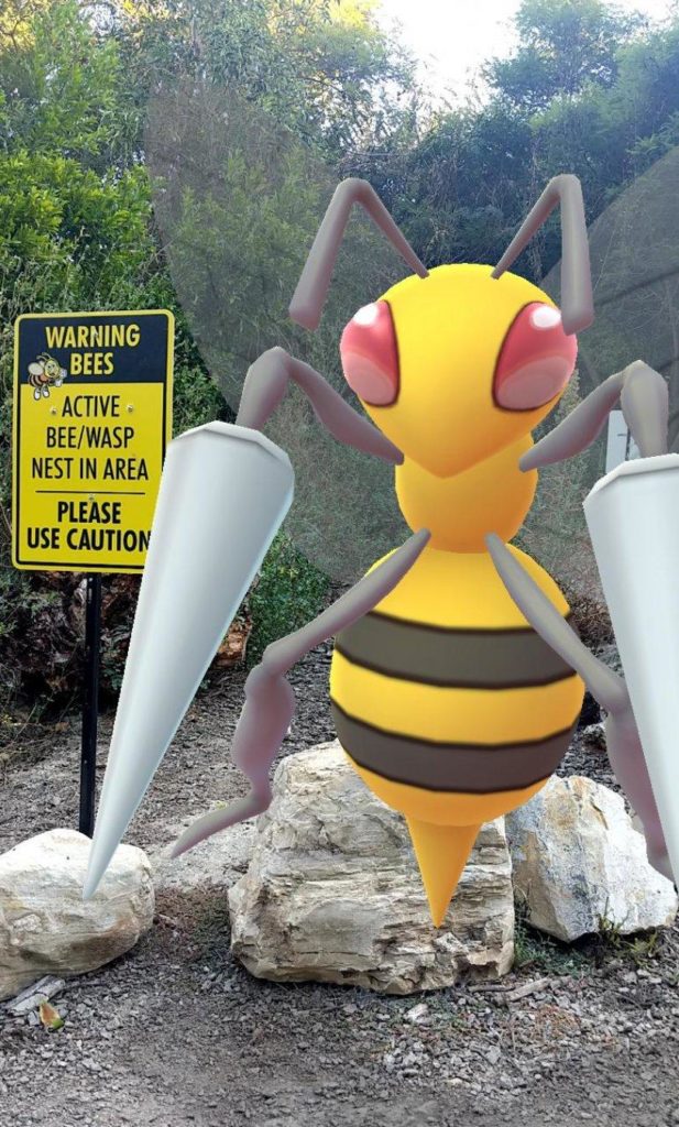Giant Beedril next to a sign saying Warning: Bees in the area!