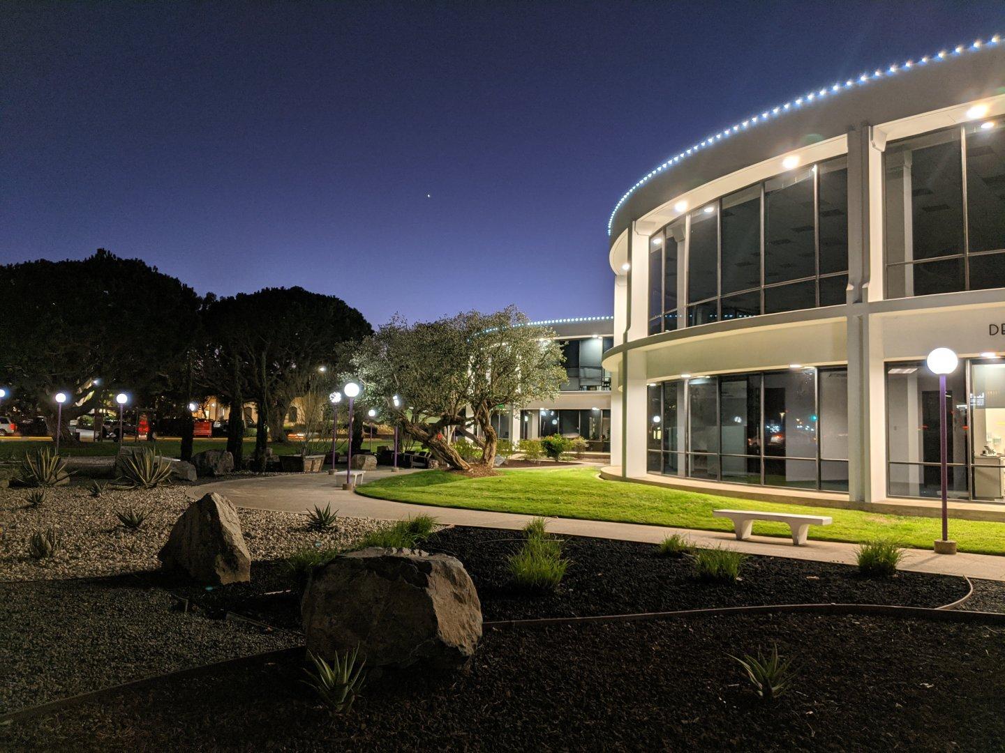 Twilight at the circular offices. There are four of these round buildings arranged in an arc around a central, taller building that's out of view. The rock gardens and drought-tolerant planters used to be lawn and fountains until they redid the landscaping a couple of years ago. #twilight #buildings #city #planter #rockGarden #round #circles
