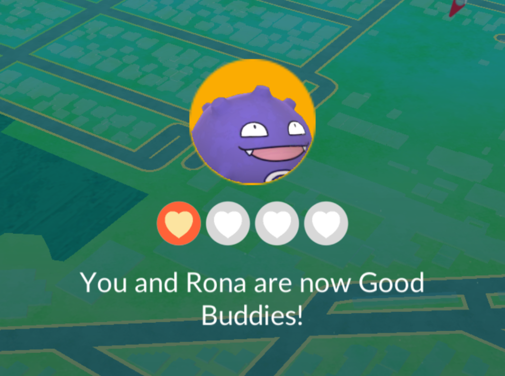 Screenshot from Pokemon Go showing a Koffing, a purple sphere with spikes all over it and a goofy grin, with a 5-heart meter and a caption: You and Rona are now good buddies!